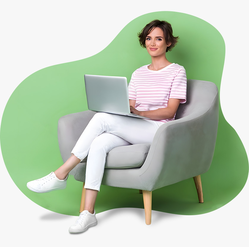 Green abstract background shape behind a woman sitting with a laptop